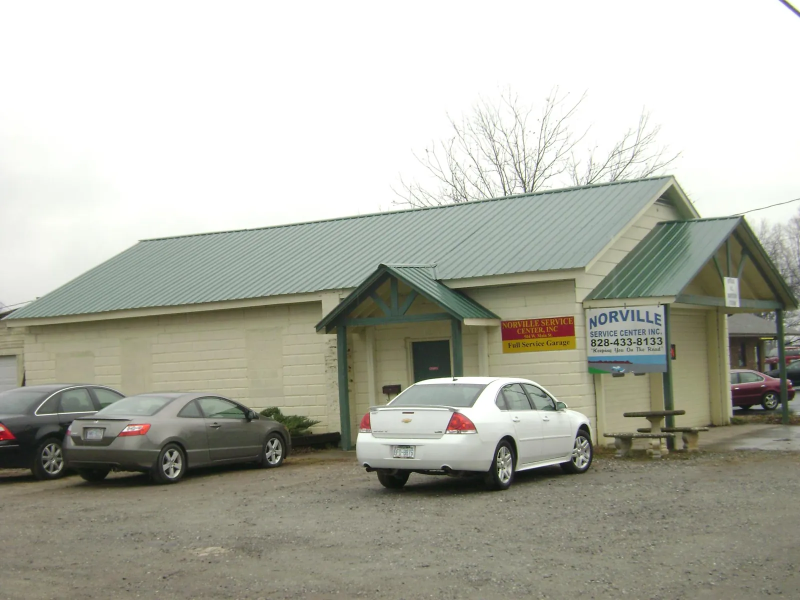 Green metal roof on a service garage with a covered entry in Snellville
