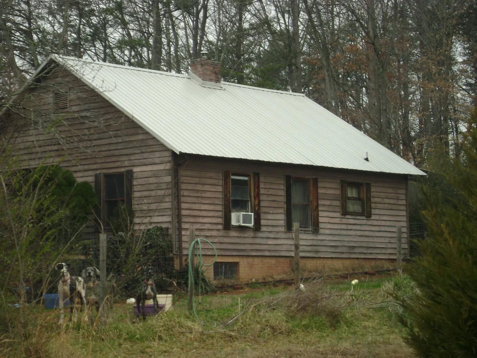 White metal roof on an old wood sided farmhouse, from a Metal Roof Installation job in Snellville